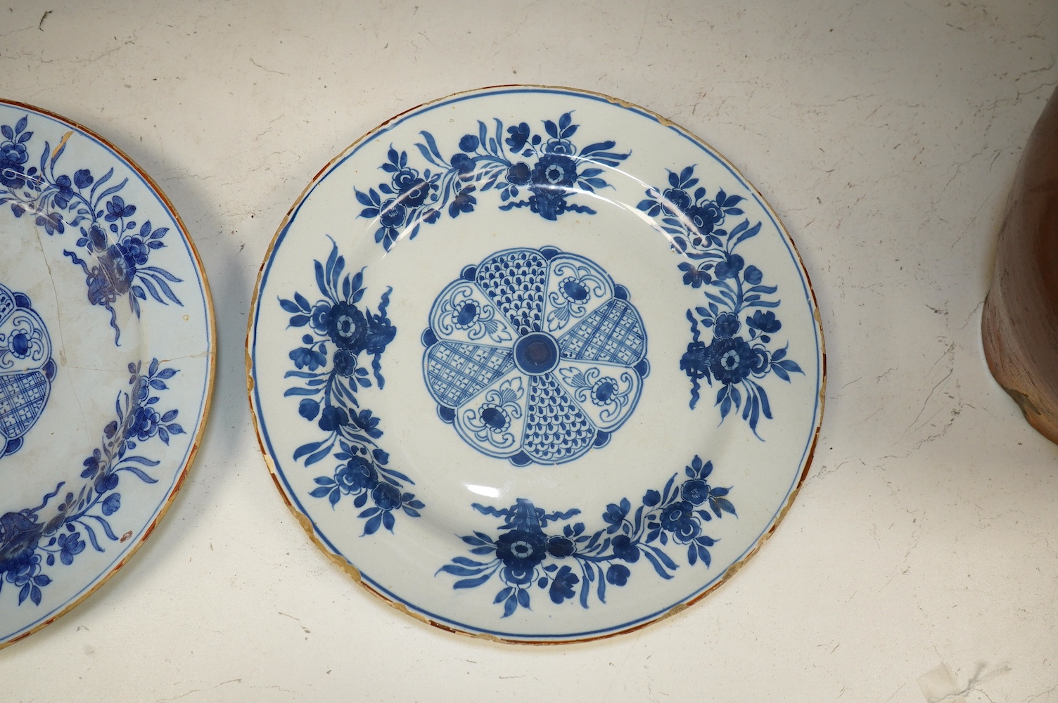 A pair of 18th century Delft plates, 30.5cm. Condition - poor